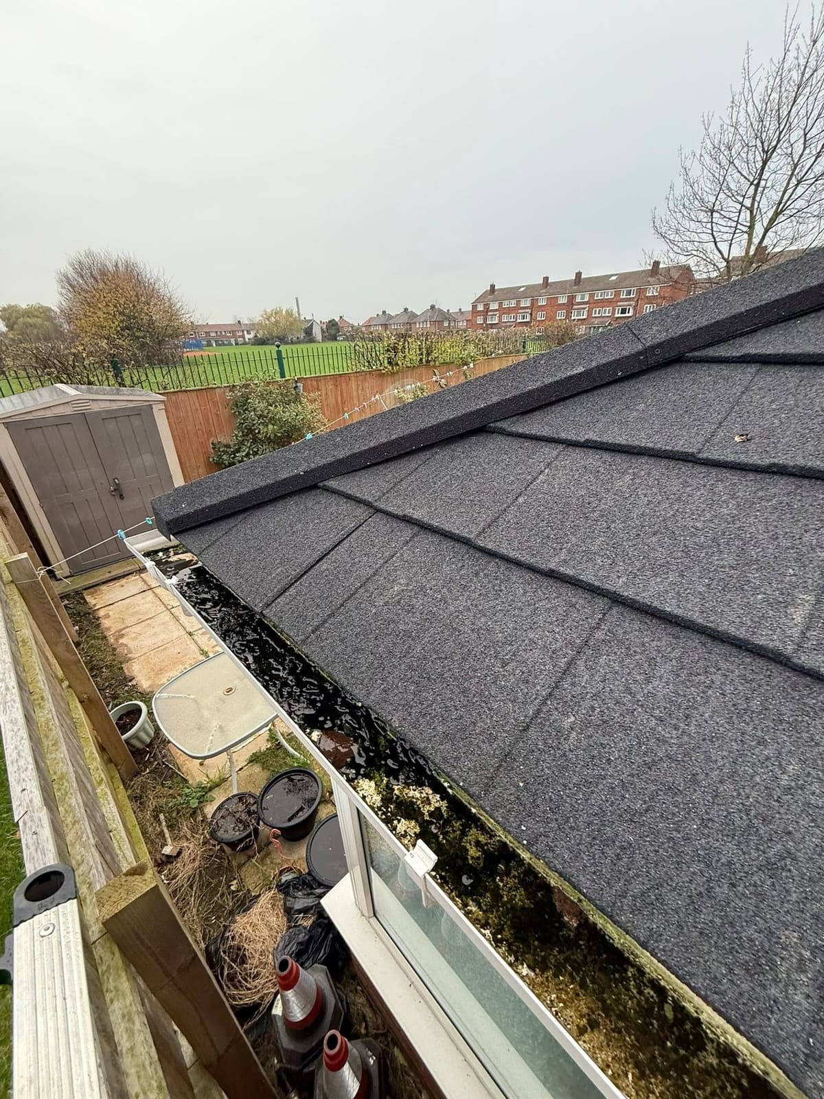 Conservatory gutter blocked with moss, then clear