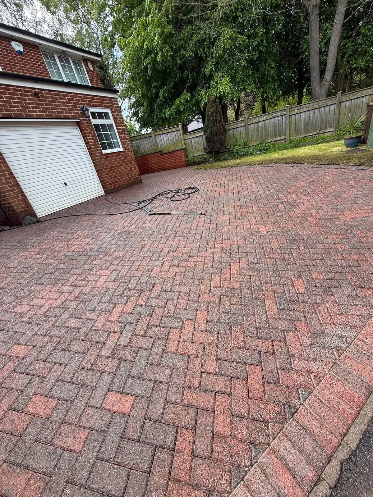 The finished driveway by the garage