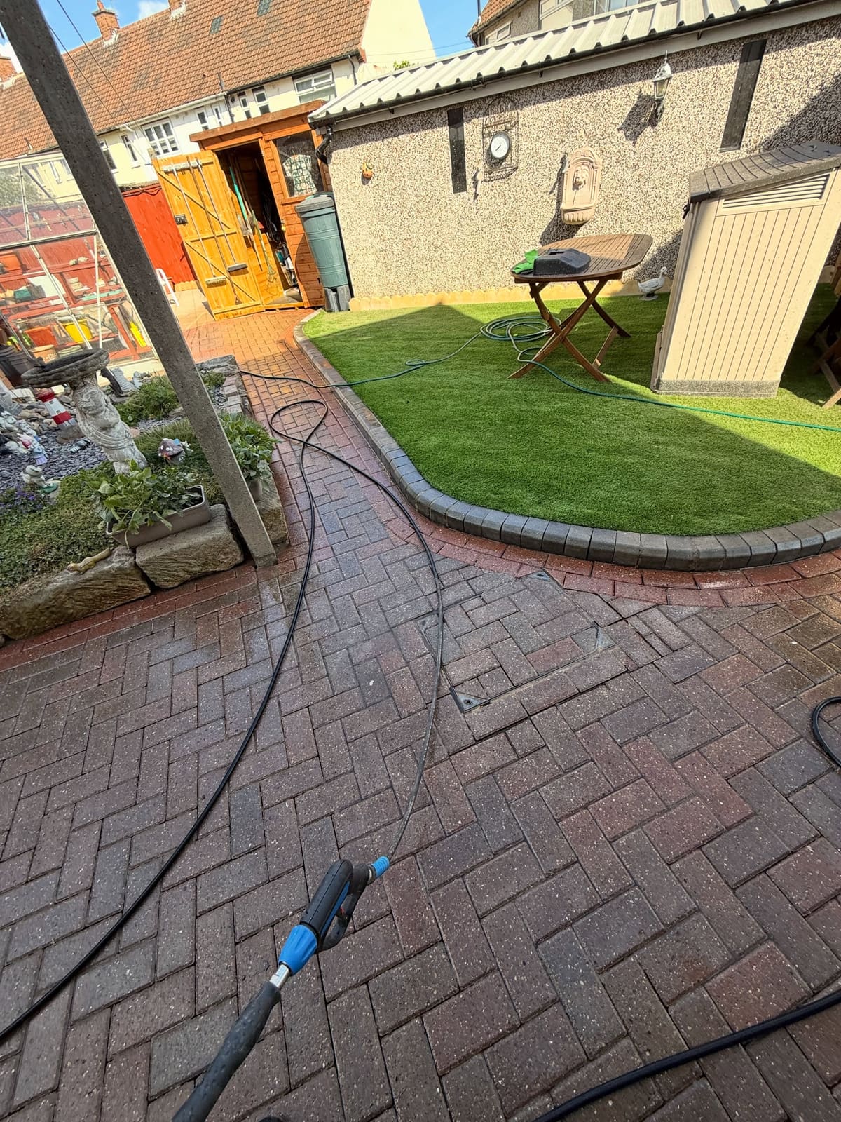 Herringbone block paving halfway through cleaning